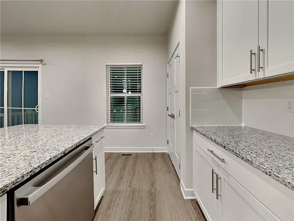 a kitchen with granite countertop wooden cabinets and a granite counter tops