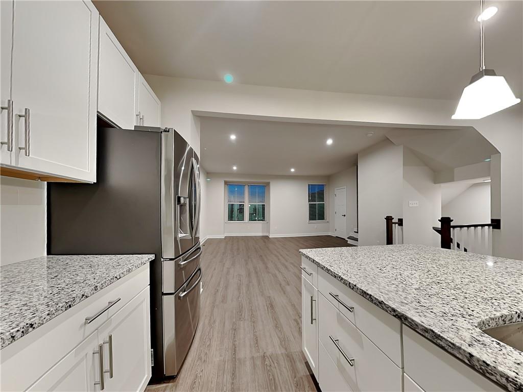 4806 Spruce Road Gibsonia, PA 15044 - Photo 8 of 49 a kitchen with stainless steel appliances granite countertop a sink refrigerator and cabinets