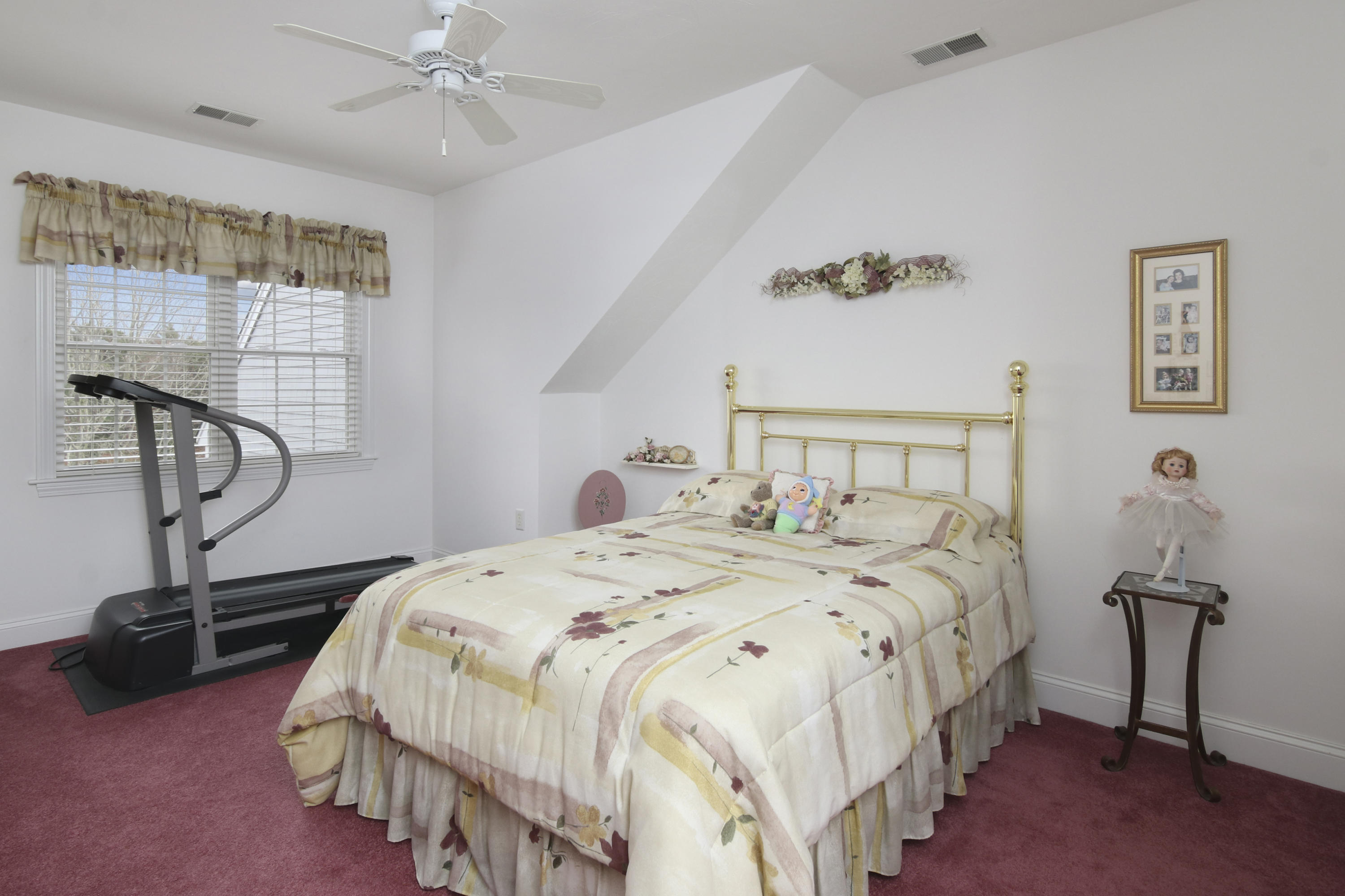 7 Prestwick Road Bourne, MA 02532 - Photo 15 of 19 a bedroom with a bed a chandelier and a window