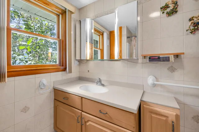 a bathroom with a sink and a window