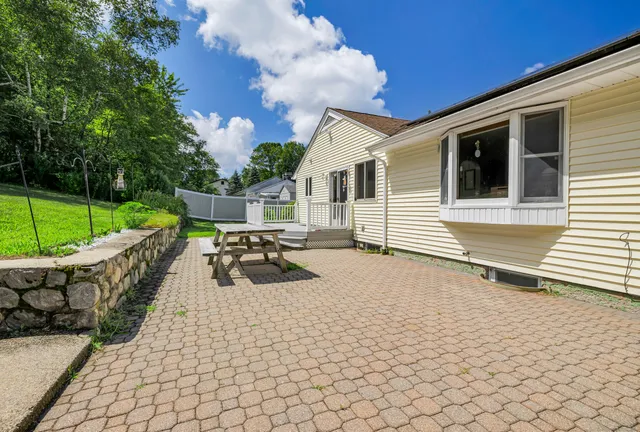 a view of a patio with wooden floor and iron fence