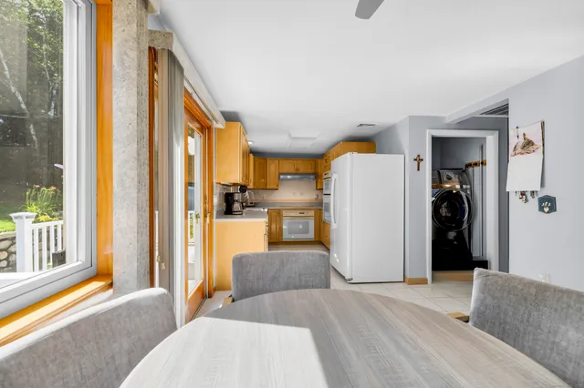 a bedroom with a bed and large windows