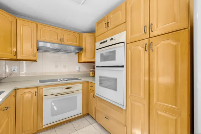 a kitchen with a stove top oven sink and cabinets