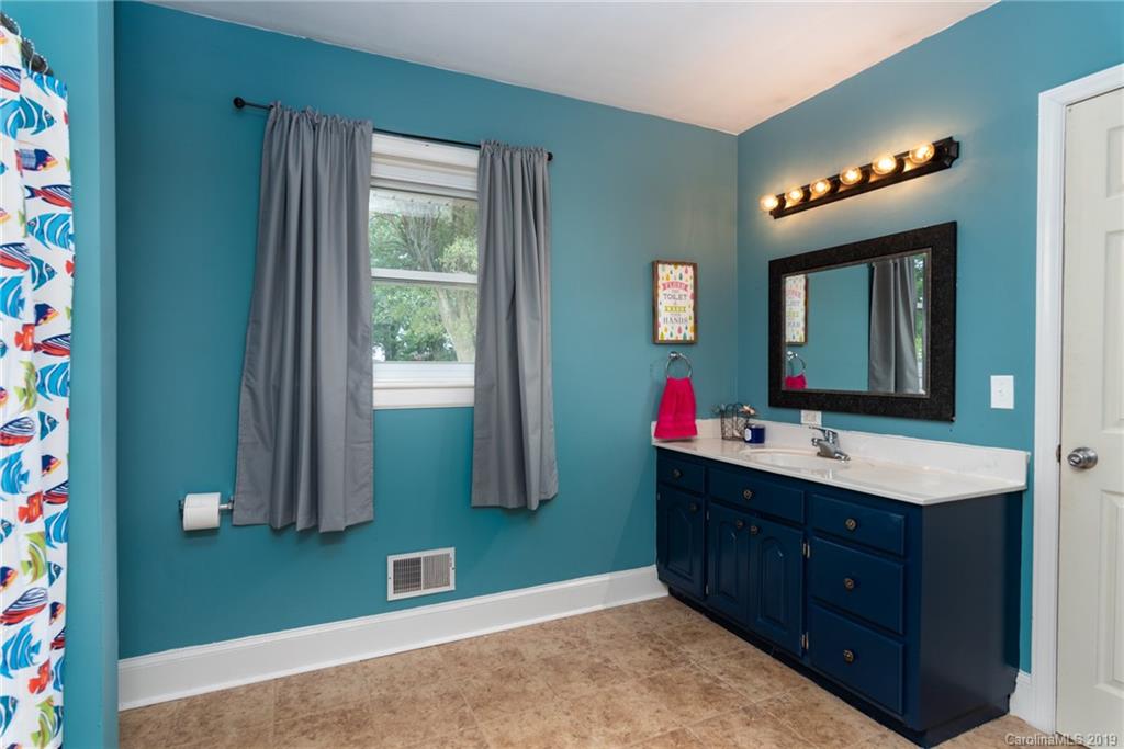 111 Flint Hill Road Cherryville, NC 28021 - Photo 22 of 24 a bathroom with a sink vanity and mirror