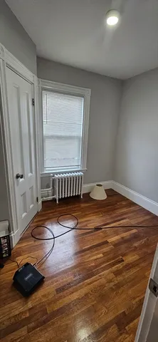 a view of a room with wooden floor and chair