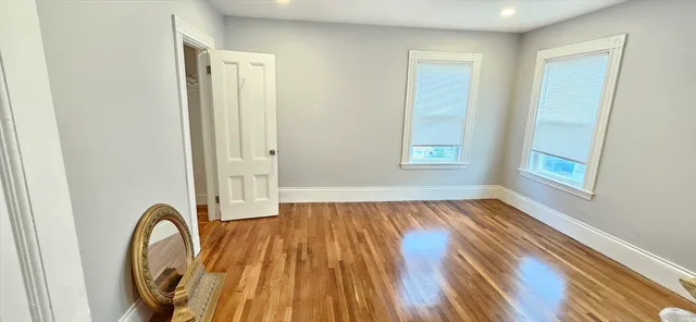 a view of a room with wooden floor and window