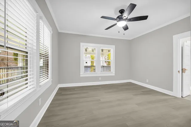 a view of an empty room with wooden floor
