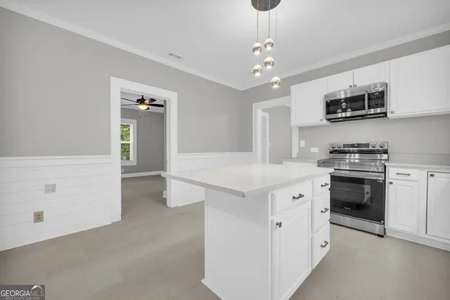 a kitchen with cabinets stainless steel appliances and a sink
