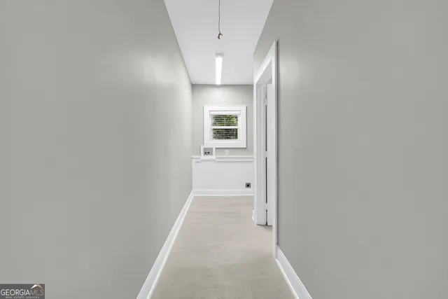 a bathroom with a toilet sink vanity and mirror