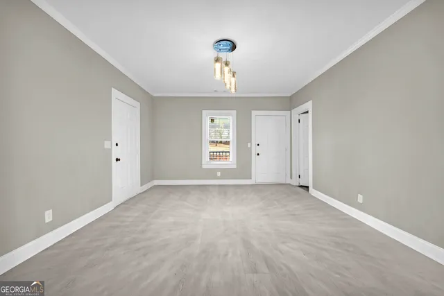 a view of a livingroom with a fireplace a ceiling fan and windows