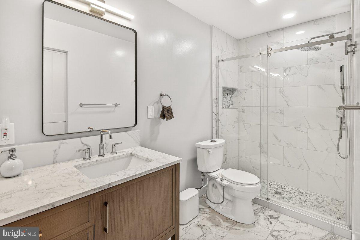 13425 Tamarack Road Silver Spring, MD 20904 - Photo 14 of 27 a bathroom with a granite countertop sink toilet and shower
