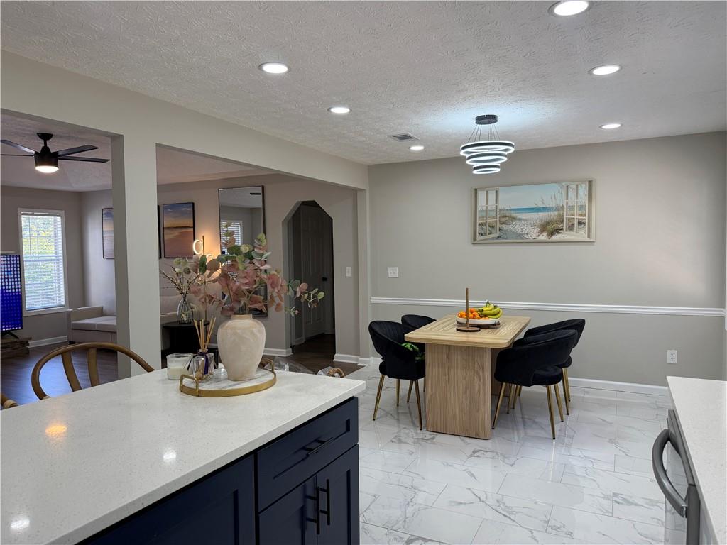 934 Bay Ridge Drive Lawrenceville, GA 30045 - Photo 47 of 78 a view of a dining room with furniture and chandelier