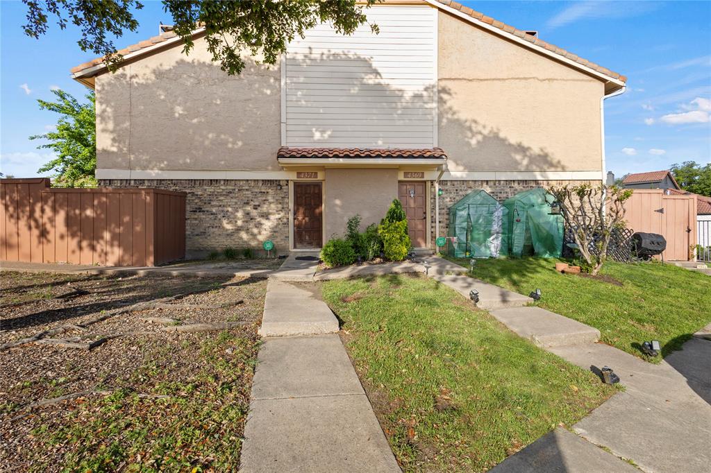 4371 Madera Road, Unit 4 Irving, TX 75038 - Photo 2 of 23 View of front of house with a shed and a front lawn