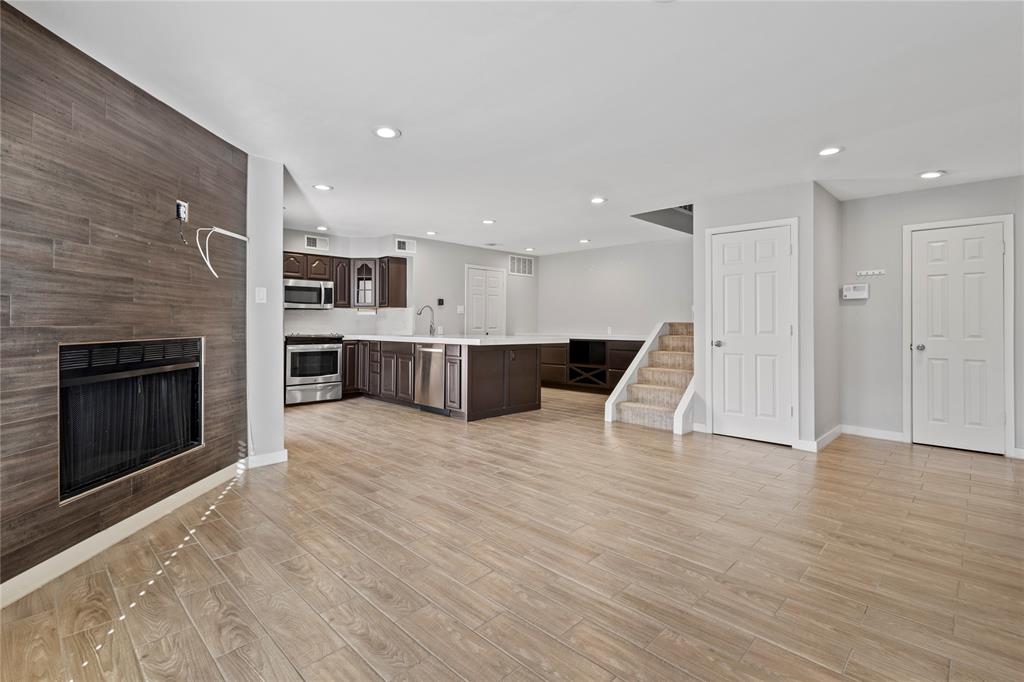 4371 Madera Road, Unit 4 Irving, TX 75038 - Photo 21 of 23 Kitchen featuring light hardwood / wood-style flooring, dark brown cabinetry, sink, and stainless steel appliances