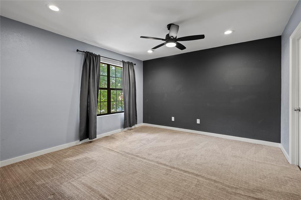 4371 Madera Road, Unit 4 Irving, TX 75038 - Photo 9 of 23 Empty room featuring light carpet and ceiling fan
