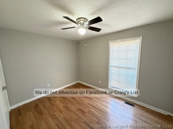 a view of a room with rack on the wall and a window