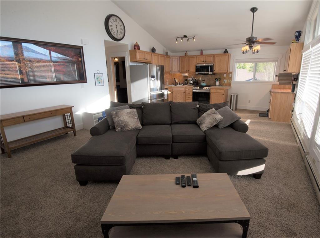 423 Big Elk Road Dillon, CO 80435 - Photo 6 of 35 a living room with furniture kitchen view and a chandelier