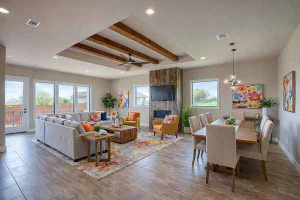 a large kitchen with stainless steel appliances kitchen island a large counter top and wooden floors