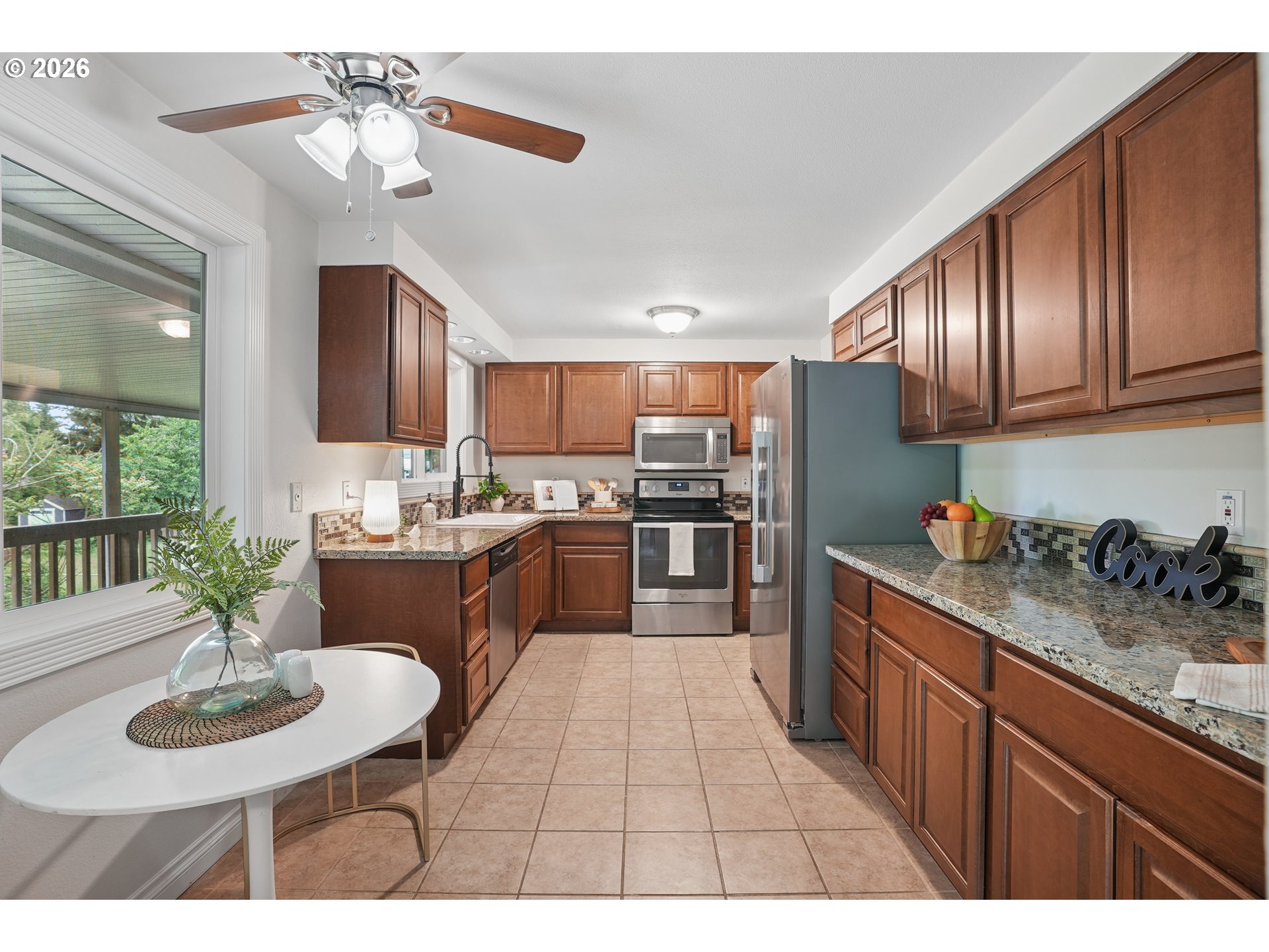 992 South South End Road Oregon City, OR 97045 - Photo 10 of 38 a kitchen with sink refrigerator dining table and chairs