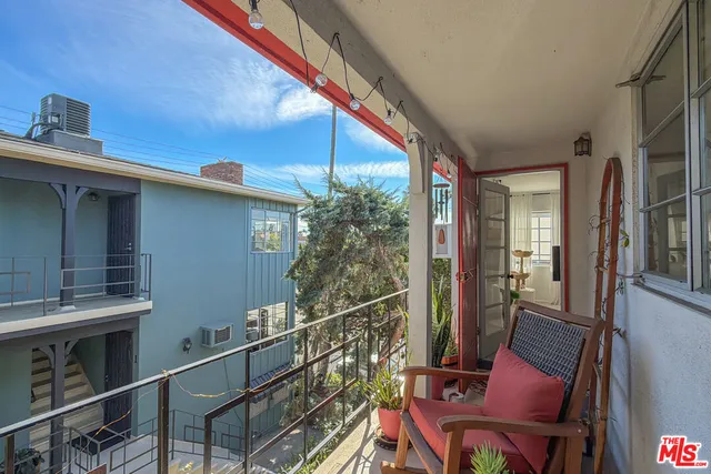 a view of balcony with wooden floor and outdoor seating