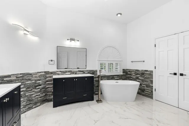 a bathroom with a sink double vanity and a mirror