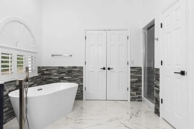 a room with a window a sink and a mirror