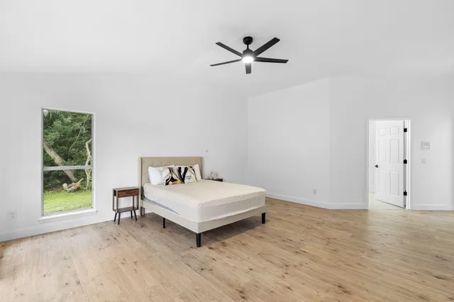 a bedroom with a bed and a window