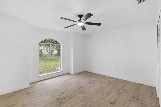 an aerial view of a house with a yard and lake view