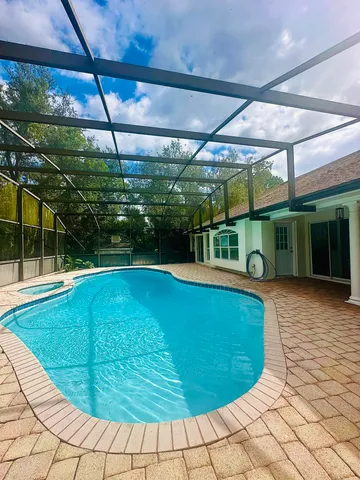 a view of a swimming pool with a patio