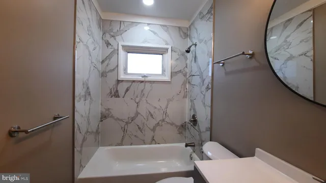 a bathroom with a bathtub and toilet