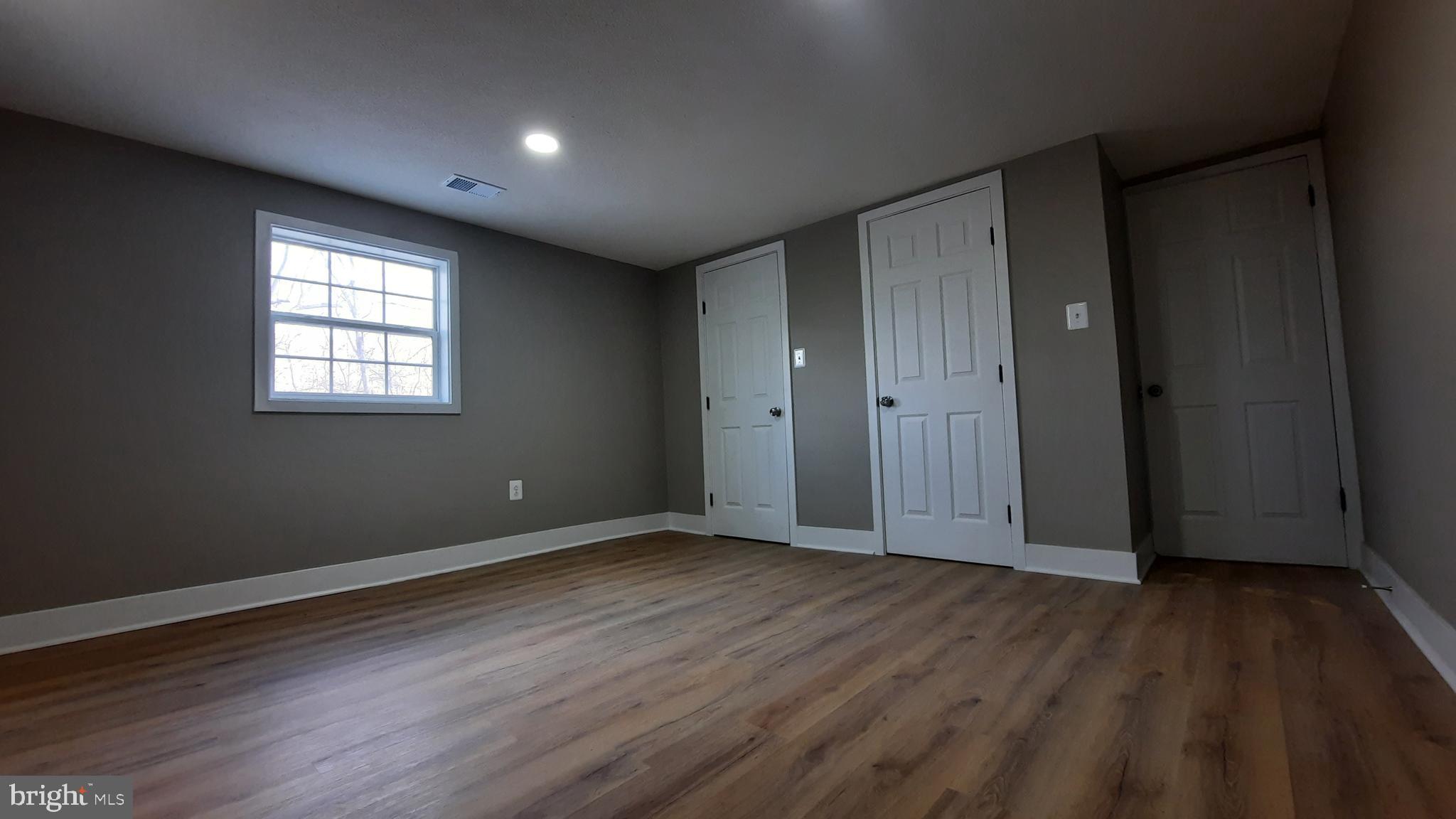373 Bowman Road Front Royal, VA 22630 - Photo 16 of 28 an empty room with wooden floor and windows