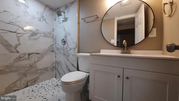 a bathroom with a sink toilet and shower