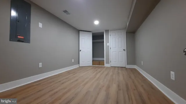 a view of an empty room with wooden floor