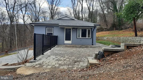 a backyard of a house with barbeque oven