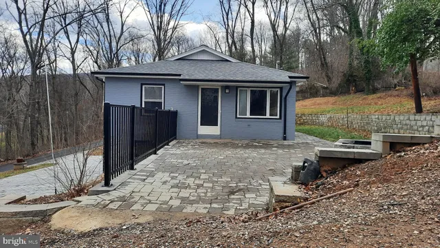 a backyard of a house with barbeque oven