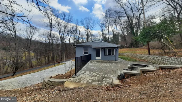 a view of a house with backyard porch and sitting area