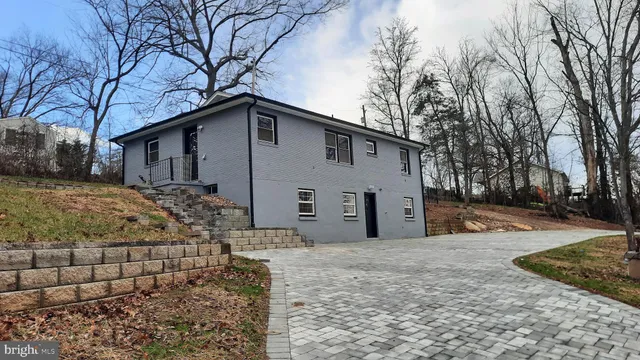 a view of a house with a yard covered in snow