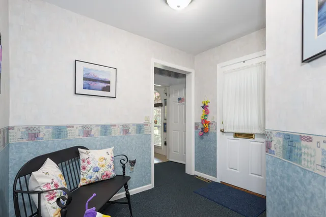 a view of a livingroom with furniture and an empty room