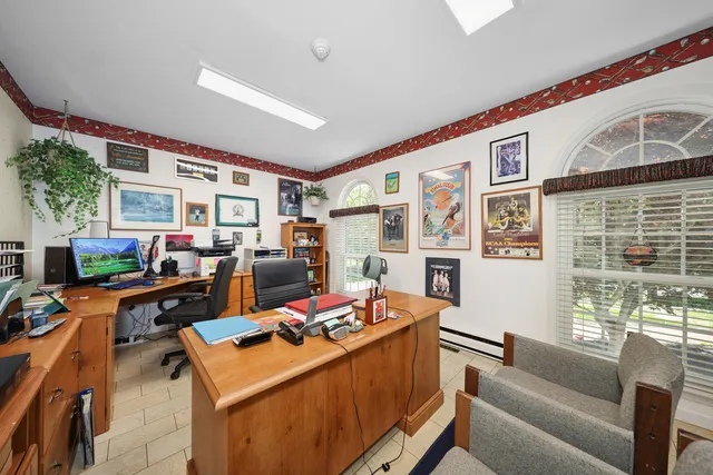 a living room with fireplace furniture and a large window