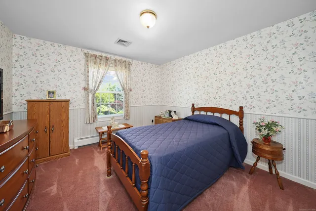 a bed room with a bed and a window