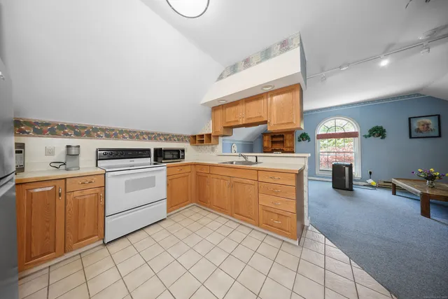 a kitchen with a stove top oven and cabinets