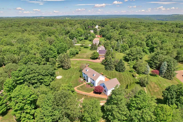 an aerial view of a house with a yard