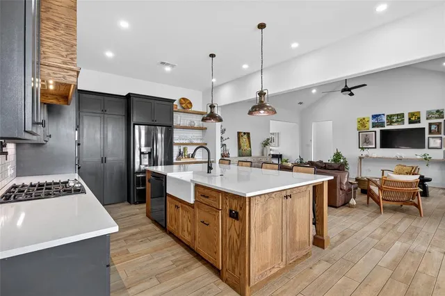 a kitchen with furniture and wooden floor