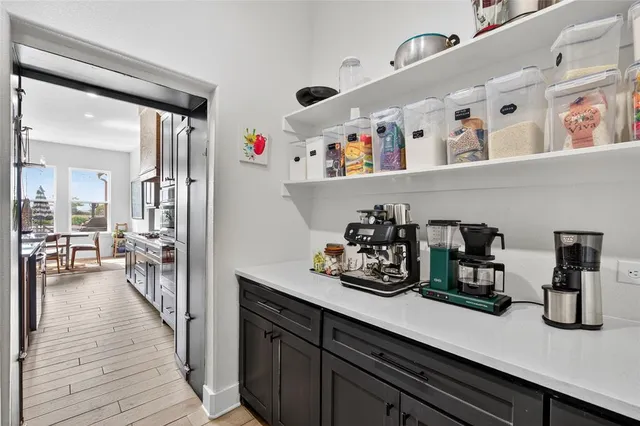a dining room with furniture potted plants and wooden floor