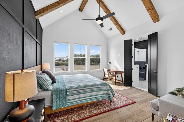 a bedroom with a bed and a lamp