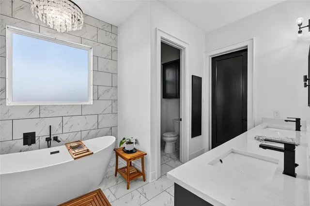 a en suite bathroom with a double vanity sink a mirror and shower