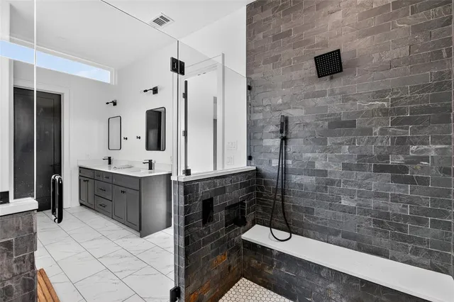 a bathroom with a shower and a mirror