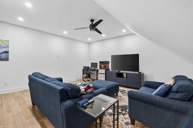 a living room with patio furniture and a floor to ceiling window