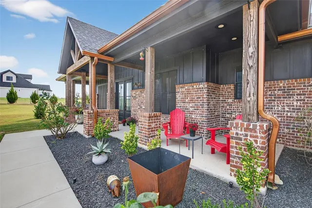 a hallway with wooden floor and windows