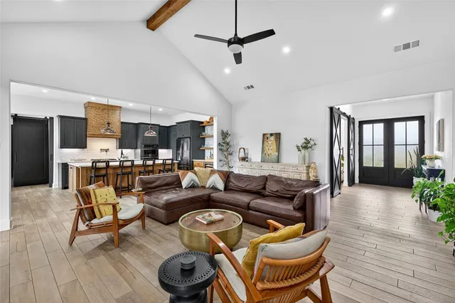 a large kitchen with a table and chairs
